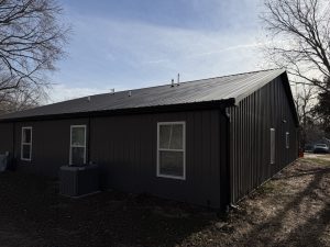 Rear exterior view of a stud-frame duplex with metal siding built by Building Pros LLC in Garnett, Kansas